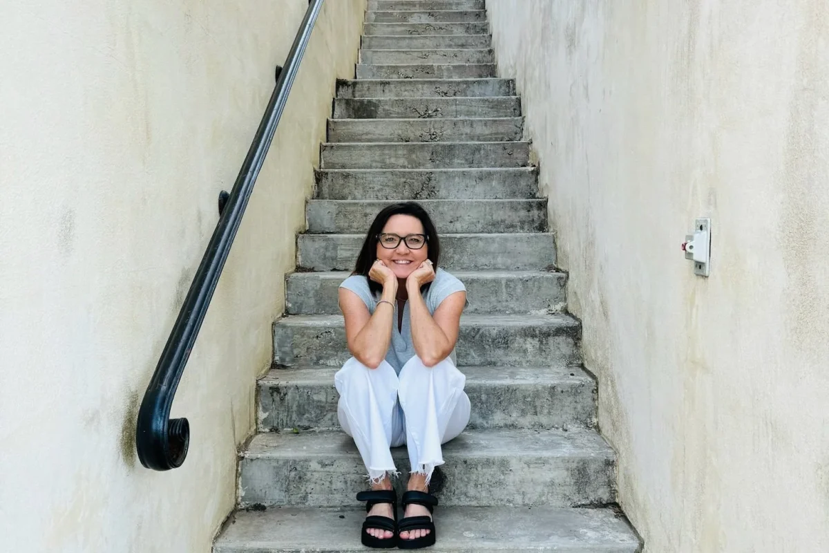 Chantell Cooley sitting on a long outdoor staircase, an image of what it takes to be strong and courageous