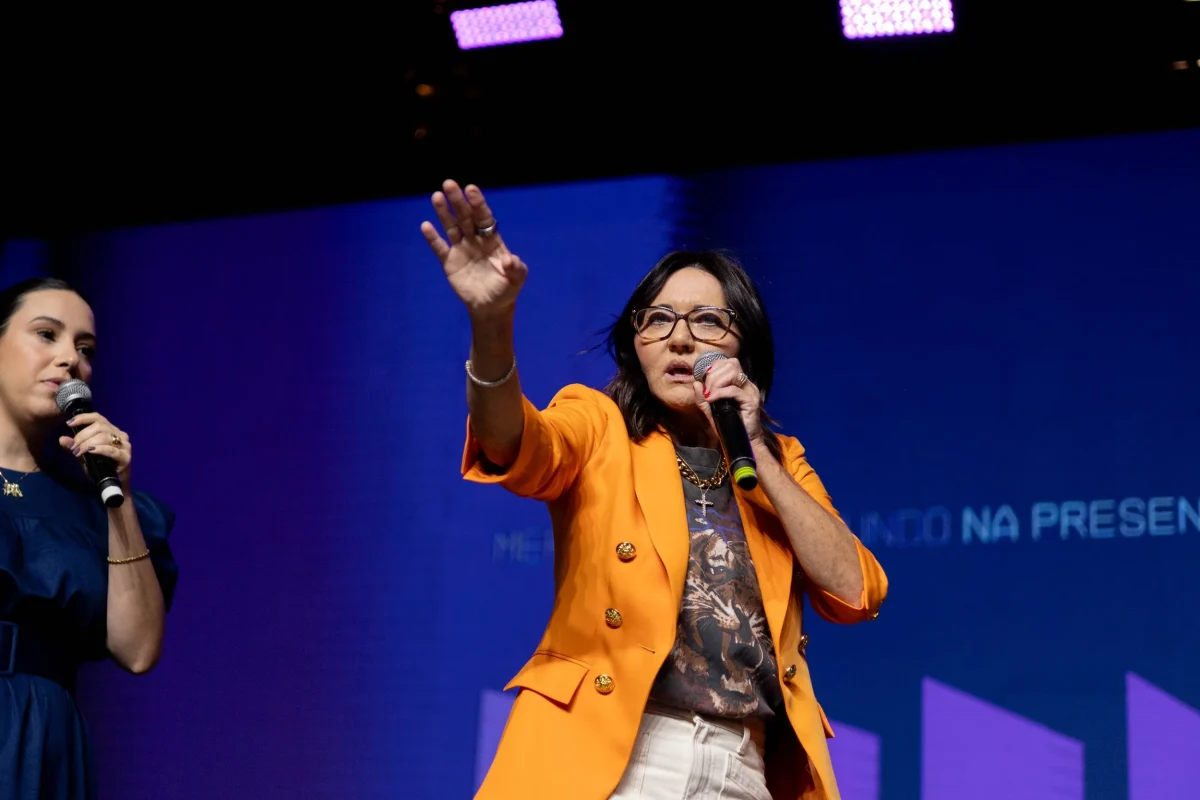 Chantell Cooley speaking on stage with a microphone, a picture of what is on the other side of surviving your own darkness