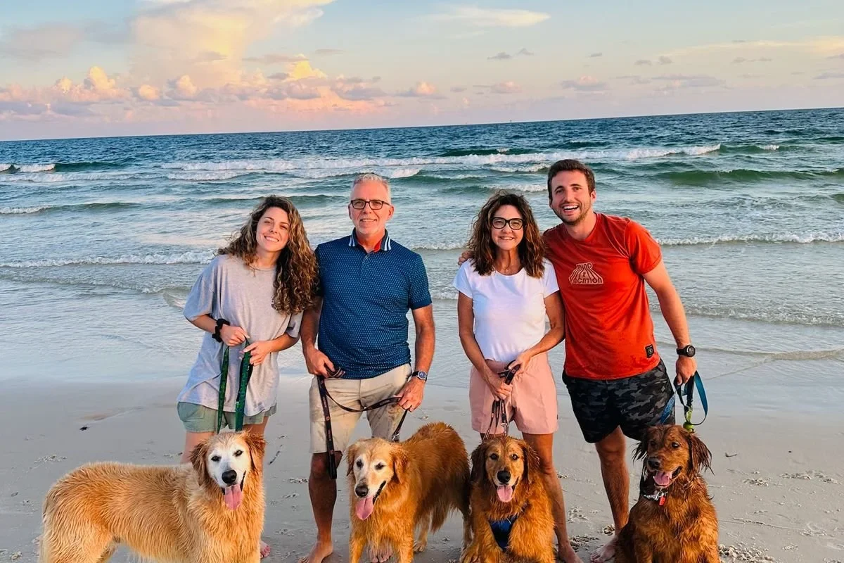 Chantell Cooley on the beach with her husband, her two grown children and their golden retrievers, the family a working mother built